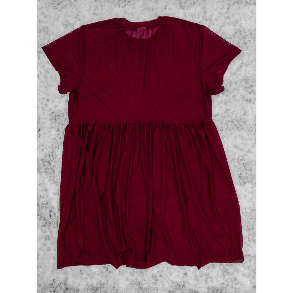 A flat lay image showcasing the back of a wine stretch mesh babydoll dress with short sleeves. The dress features soft, luxurious fabric in rich colors. The background is neutral, highlighting the dress's details and textures.