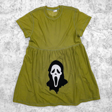 A flat lay image showcasing a avocado green stretch mesh babydoll dress with short sleeves adorned with an evocative Ghostface appliqué from 90s meta-horror classic Scream (1996). The background is neutral, highlighting the dress's details and textures.