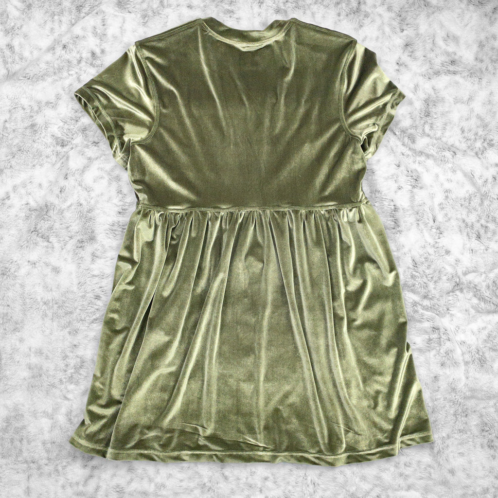 A flat lay image showcasing the back of a olive green velvet babydoll dress with short sleeves. The dress features soft, luxurious fabric in rich colors. The background is neutral, highlighting the dress's details and textures.