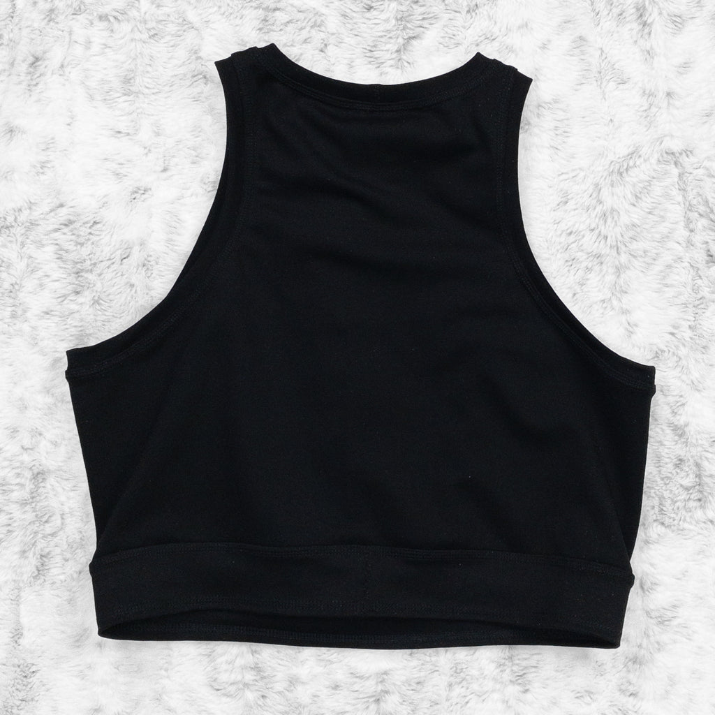 A flat lay image showcasing the back of a black 4-way stretch ponte knit crewneck close cut crop with princess seams and a ribcage appliqué on the centerfront. The top features soft, luxurious fabric in an inky black. The background is neutral, highlighting the shorts' details and textures.